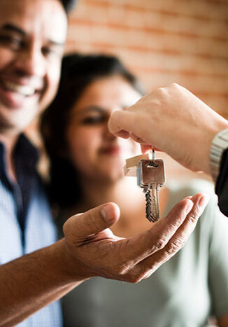bigstock-Cheerful-couple-with-keys-to-t-270960697